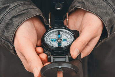 woman holding old compass