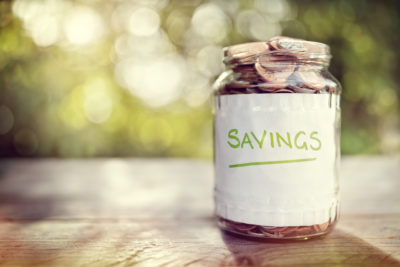 Savings money jar full of coins concept for saving or investment for a house, retirement or education, financial peace, finances